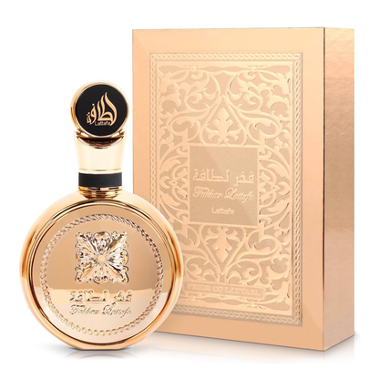 Gold perfume bottle and packaging with intricate designs on a white background