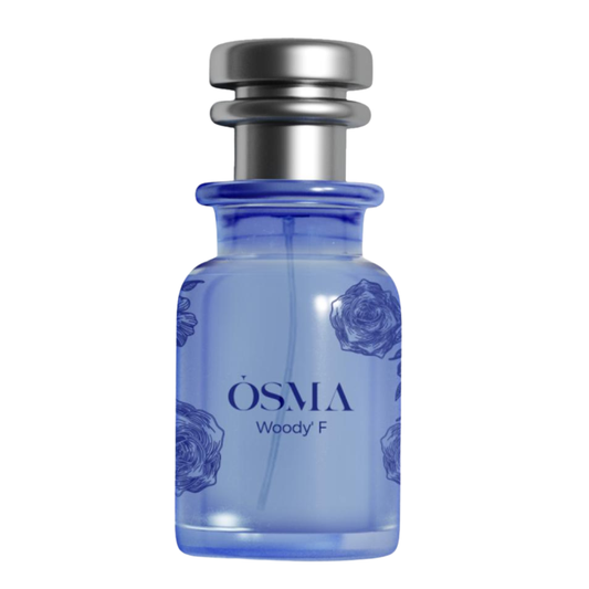 Blue perfume bottle with silver cap on a white background